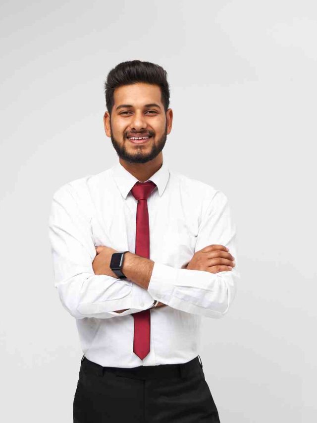 portrait-young-indian-top-manager-t-shirt-tie-crossed-arms-smiling-white-isolated-wall (1)