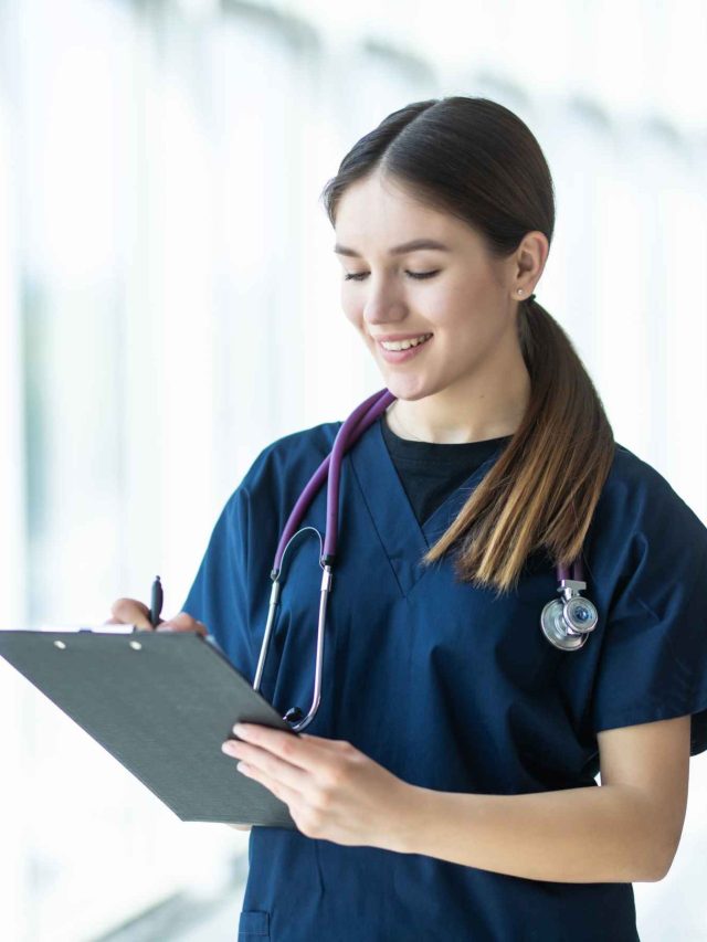 smiling-young-female-doctor-holding-clipboard-hospital (1)